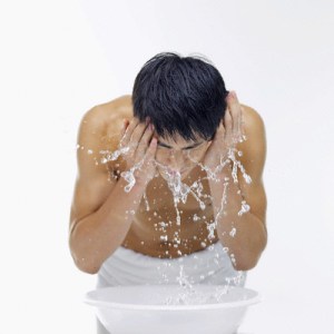 Man splashing water onto face