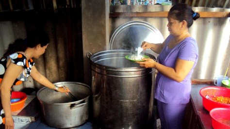 Bếp trưởng Dạ Thảo (trái) và bếp phó Mỹ Hạnh bên bếp lò đỏ lửa từ 3g sáng lo bữa cơm từ thiện cho thực khách lúc rạng đông - Ảnh: Tấn Đức