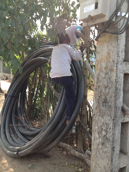 1/ Ảnh em Hoal và em Xiêm đang trèo lên cuộn dây tưới cà-phê của nhà bố mẹ Kali